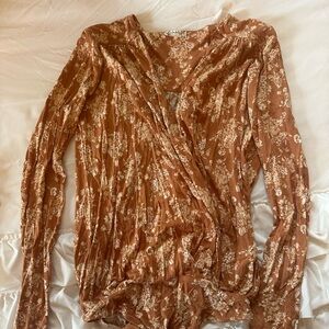 Free People Floral Wrap Top in orange.